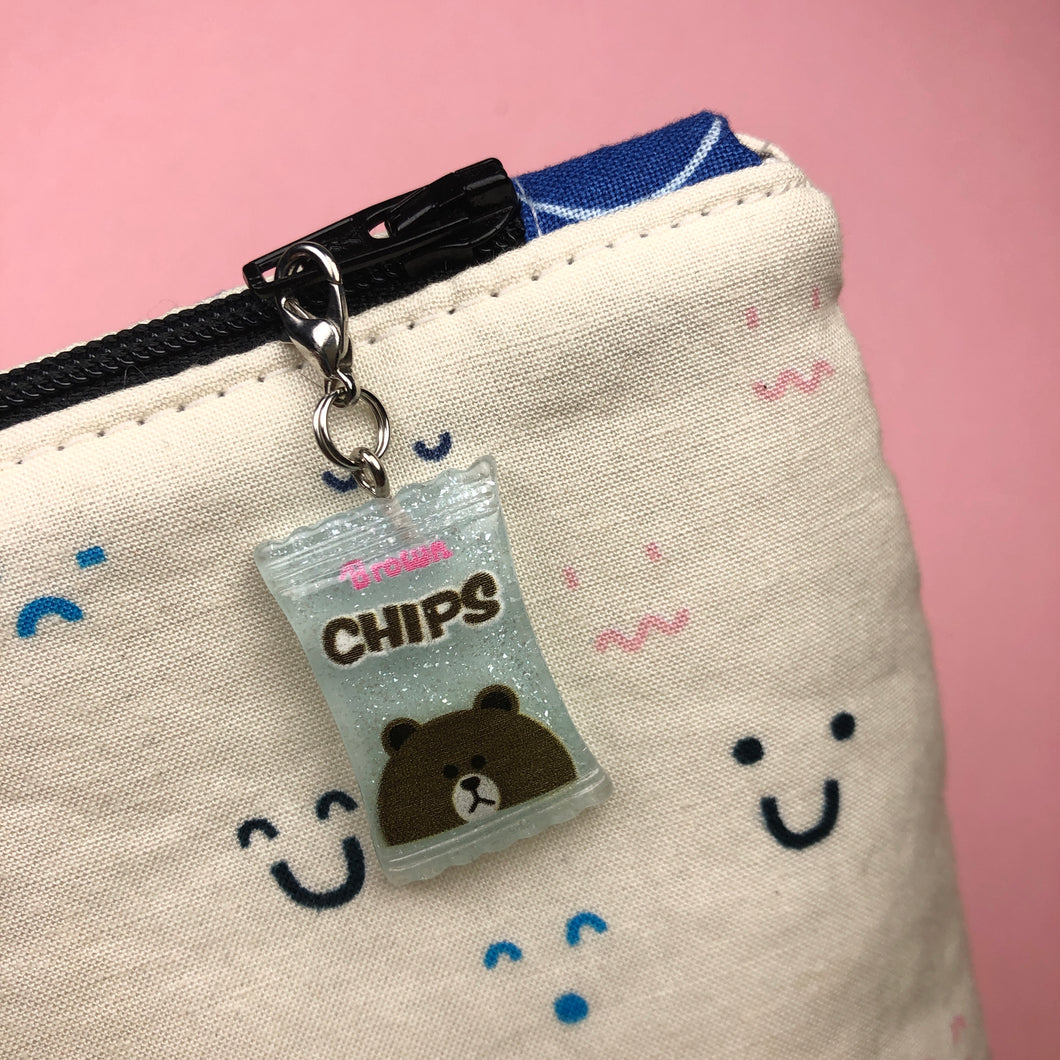 zipper bag with green bear charm hanging from zipper 